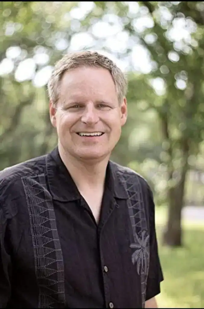 Man smiling outdoors, representing Swift Response Crypto team member.